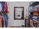 Organized walk-in closet with clothing racks, shelves, mirror, and wood flooring, offering ample storage space at 3419 Brickyard Ln, Midland, NC 28107