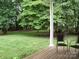 Inviting back porch with chairs, offering a relaxing outdoor space overlooking the lush backyard at 390 Robinson Rd, Mooresville, NC 28117