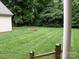 Backyard featuring a fire pit and well-maintained lawn, ideal for relaxation and outdoor activities at 390 Robinson Rd, Mooresville, NC 28117