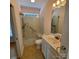 Accessible bathroom featuring a roll-in shower, handheld showerhead, and a single sink vanity at 390 Robinson Rd, Mooresville, NC 28117