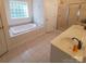 Bathroom featuring a soaking tub, tile flooring, double vanity, and glass enclosed shower at 390 Robinson Rd, Mooresville, NC 28117