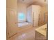 Bright bathroom with a separate shower and soaking tub under a glass block window at 390 Robinson Rd, Mooresville, NC 28117