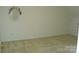 Bedroom boasting neutral carpet, round wall mirror and ample natural light at 390 Robinson Rd, Mooresville, NC 28117