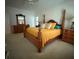 Spacious bedroom with a wooden four-poster bed, carpeted floor, and neutral-toned walls at 390 Robinson Rd, Mooresville, NC 28117