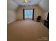 Spacious bonus room with neutral carpet, great natural light and ceiling fan at 390 Robinson Rd, Mooresville, NC 28117