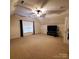 Large bonus room with neutral carpet, ceiling fan and ample room for entertaining at 390 Robinson Rd, Mooresville, NC 28117