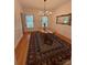 Charming dining area with a wooden table, classic wainscoting, and hardwood floors at 390 Robinson Rd, Mooresville, NC 28117