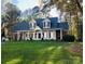 Attractive two-story home with a covered front porch, set on a well-maintained lawn at 390 Robinson Rd, Mooresville, NC 28117