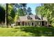 Inviting two-story home with a full front porch and lush green lawn at 390 Robinson Rd, Mooresville, NC 28117
