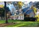 Charming two-story home with a welcoming front porch and beautifully landscaped yard at 390 Robinson Rd, Mooresville, NC 28117