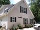 Charming home featuring a two-story elevation with dark shutters and lush landscaping at 390 Robinson Rd, Mooresville, NC 28117