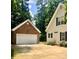 Charming exterior of home and detached garage with manicured landscaping at 390 Robinson Rd, Mooresville, NC 28117