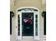 Inviting front door adorned with a patriotic wreath, set between two sidelights at 390 Robinson Rd, Mooresville, NC 28117