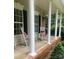 Charming front porch with rocking chairs and views of the surrounding greenery at 390 Robinson Rd, Mooresville, NC 28117