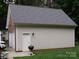 Exterior view of detached garage featuring a light siding, roof, and additional side access door at 390 Robinson Rd, Mooresville, NC 28117