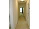 Hallway with neutral carpet leading to rooms, natural light, and white trim at 390 Robinson Rd, Mooresville, NC 28117
