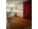 Spacious kitchen showcasing hardwood floors, white cabinets, and stainless steel appliances at 390 Robinson Rd, Mooresville, NC 28117