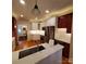 Open kitchen with stainless appliances, white cabinets and countertops, and hardwood floors at 390 Robinson Rd, Mooresville, NC 28117