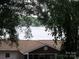 Partial lake view from the property, framed by mature trees at 390 Robinson Rd, Mooresville, NC 28117