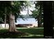 A picturesque lake view peeks through mature trees at 390 Robinson Rd, Mooresville, NC 28117