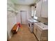Convenient laundry room equipped with a washer, dryer, sink, storage cabinets, and bench at 390 Robinson Rd, Mooresville, NC 28117