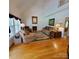 Bright living room with hardwood floors, a fireplace, large windows, and comfortable seating at 390 Robinson Rd, Mooresville, NC 28117