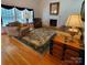 Cozy living room featuring hardwood floors, fireplace, area rug, and a window with natural light at 390 Robinson Rd, Mooresville, NC 28117