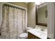 Full bathroom featuring a shower with patterned curtain, vanity, mirror, and tiled flooring at 400 Majolica Rd, Salisbury, NC 28147