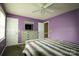 Bedroom featuring light purple walls, carpeted floors, and a bright, airy feel with natural light at 400 Majolica Rd, Salisbury, NC 28147