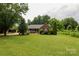 Inviting brick ranch-style home with a lush green lawn and mature trees at 400 Majolica Rd, Salisbury, NC 28147