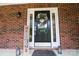 Inviting front porch with brick facade, stylish wreath and decorative lantern at 400 Majolica Rd, Salisbury, NC 28147