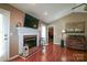 Living room with a brick fireplace and hardwood floors creating a warm ambiance at 400 Majolica Rd, Salisbury, NC 28147