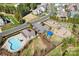 Aerial view of a neighborhood pool, playground, and green space, perfect for Gathering fun and recreation at 4012 Woodsmill Rd, Fort Mill, SC 29707