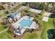 This aerial view shows a community pool with a slide, tennis courts, and ample parking at 4012 Woodsmill Rd, Fort Mill, SC 29707