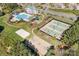 This aerial shows the pool, tennis courts, volleyball court, and playground in the community at 4012 Woodsmill Rd, Fort Mill, SC 29707