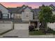 Charming two-story townhome featuring a two-car garage, stylish grey siding, and well-manicured landscaping at 4012 Woodsmill Rd, Fort Mill, SC 29707