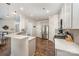 Well-lit kitchen with stainless steel appliances, white cabinets, and bar seating overlooking the dining area at 4012 Woodsmill Rd, Fort Mill, SC 29707