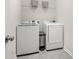Laundry room with front load washer and dryer and overhead shelving at 4012 Woodsmill Rd, Fort Mill, SC 29707