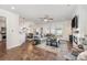 Open-concept living room with hardwood floors, modern decor, and ample natural light at 4012 Woodsmill Rd, Fort Mill, SC 29707