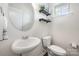 Bright powder room with pedestal sink, decorative shelves, and a window for natural light at 4012 Woodsmill Rd, Fort Mill, SC 29707