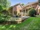 An outdoor patio and well-manicured backyard provides an outdoor gathering space at 4026 Sharon View Rd, Charlotte, NC 28226