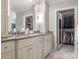 Spacious bathroom featuring double vanity, granite countertop, and walk-in closet at 4026 Sharon View Rd, Charlotte, NC 28226