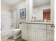 Well-lit bathroom with a shower-tub, granite countertop, and stylish white cabinets at 4026 Sharon View Rd, Charlotte, NC 28226