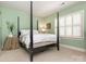 Bedroom featuring a four poster bed, neutral carpet and a light green wall at 4026 Sharon View Rd, Charlotte, NC 28226