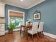Bright breakfast nook with wood table and seating, overlooking the landscaped backyard at 4026 Sharon View Rd, Charlotte, NC 28226