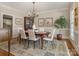 Inviting dining room with wood floors, decorative rug, table and chairs, and hutch at 4026 Sharon View Rd, Charlotte, NC 28226