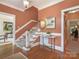 Warm and inviting foyer with staircase, hardwood floors, and stylish decor at 4026 Sharon View Rd, Charlotte, NC 28226