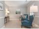 Cozy sitting area with blue upholstered chairs, carpet and wainscoting at 4026 Sharon View Rd, Charlotte, NC 28226