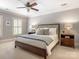 Bright main bedroom featuring neutral colors, a ceiling fan, and two bedside tables with lamps at 4026 Sharon View Rd, Charlotte, NC 28226