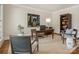 Classic office with a large wooden desk, chairs, and built-in bookshelves at 4026 Sharon View Rd, Charlotte, NC 28226